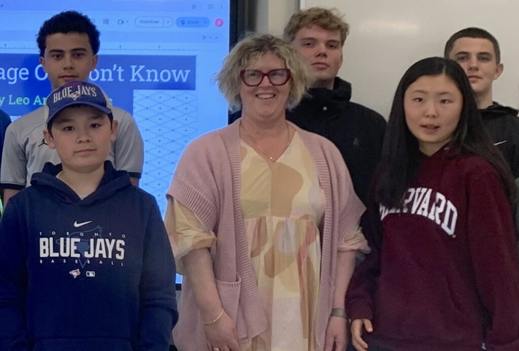 We will overcome these uncertain times - Helen Lami with students